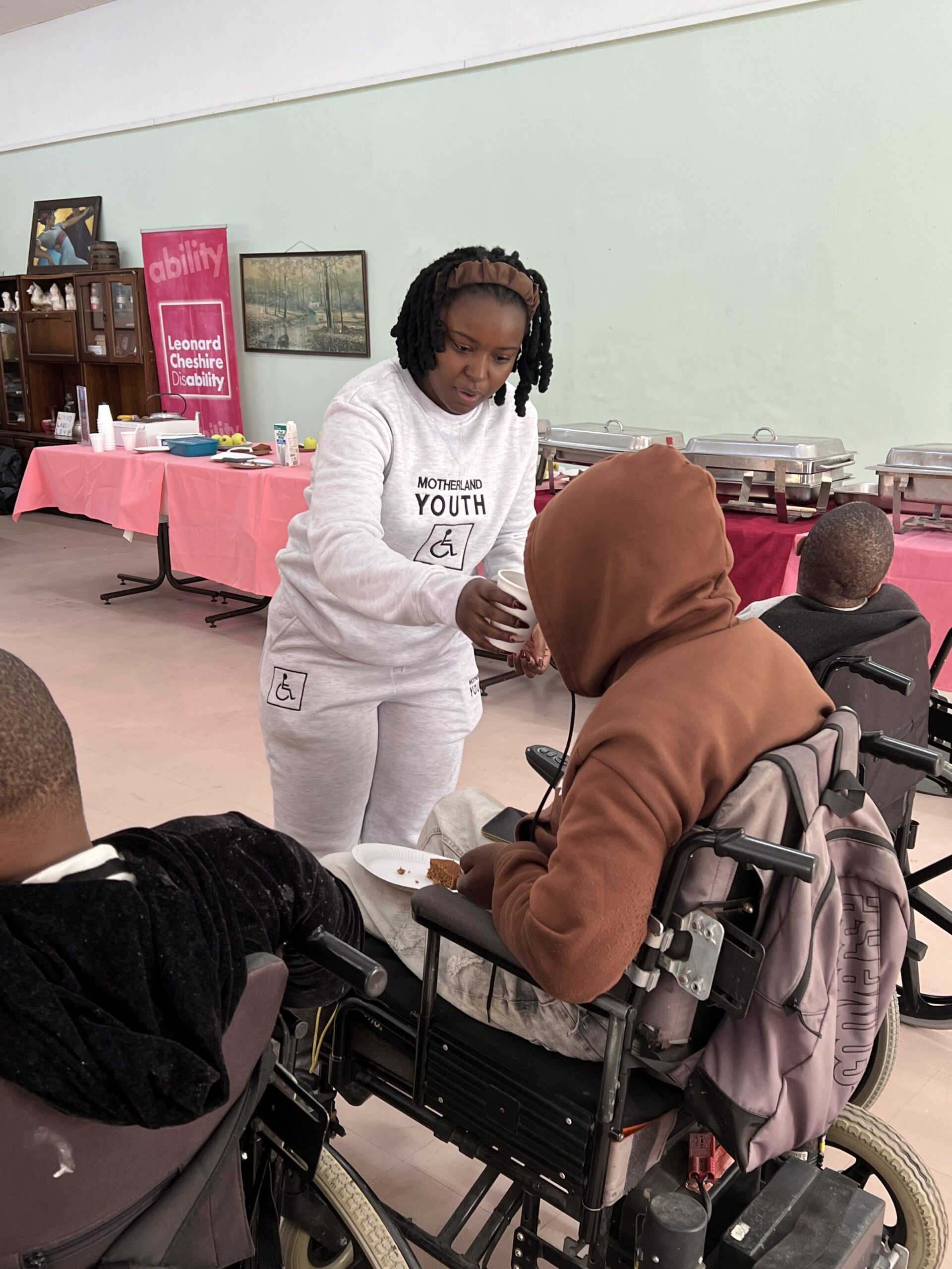 Volunteer serving a resident seated in a wheelchair